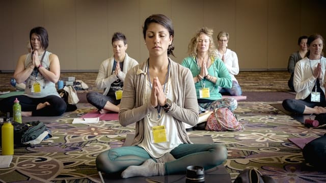 people practicing group meditation