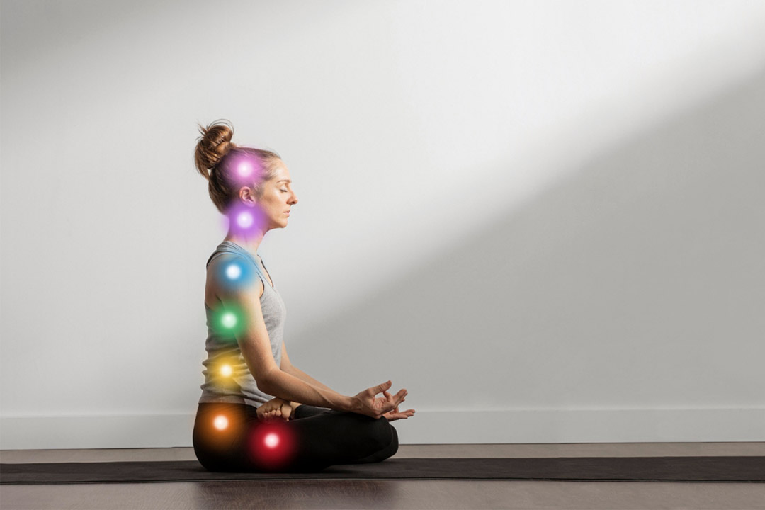 woman maintaining asana while chakra points are aligned