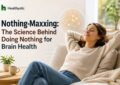 A young person sitting quietly with no phone or earbuds, practicing intentional stillness as part of the nothing-maxxing wellness trend